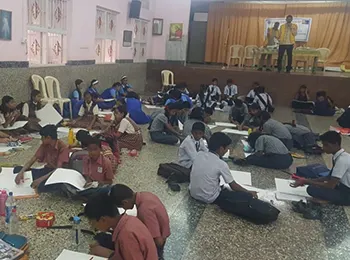 Students taking part in a drawing competition in a school hall